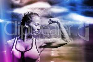 Composite image of fit woman flexing muscles