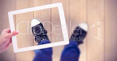 Composite image of masculine hand holding tablet