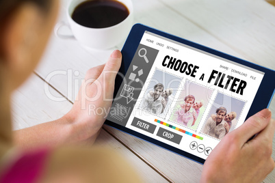 Composite image of woman using tablet pc