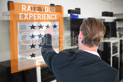 Composite image of rear view of young businessman in suit pointi