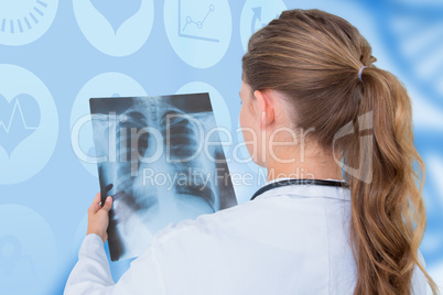 Composite image of focus doctor looking at x-rays