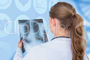 Composite image of focus doctor looking at x-rays