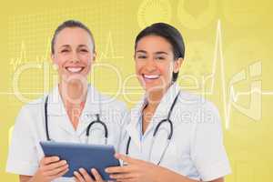 Composite image of nurses with tablet pc