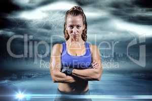 Composite image of portrait of fit woman with arms crossed