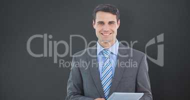 Composite image of businessman using a tablet  with colleagues b