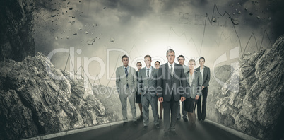 Composite image of smiling business team looking at camera