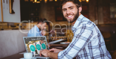 Composite image of young man working on his computer