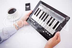 Composite image of man using tablet pc