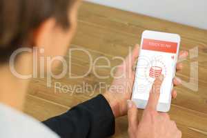 Composite image of businesswoman using phone at desk