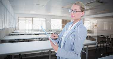 Composite image of businesswoman using digital tablet