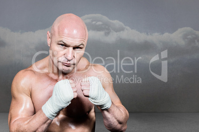 Composite image of portrait of confident man with fighting stanc