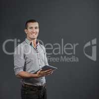 Composite image of handsome businessman using digital tablet ove