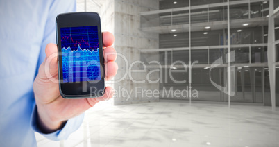 Composite image of businessman showing his smartphone to camera