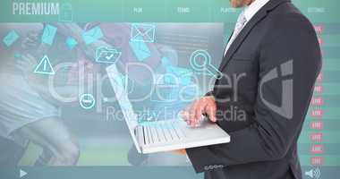 Composite image of businessman holding laptop