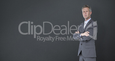 Composite image of businessman standing arms crossed over white