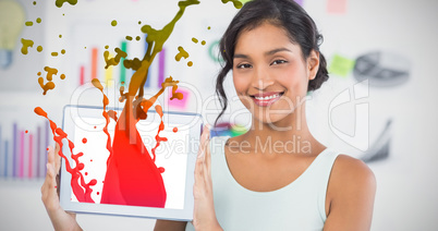 Composite image of happy businesswoman showing digital tablet in