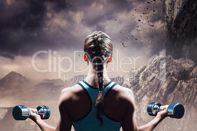 Composite image of rear view of braided hair woman lifting dumbb