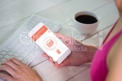 Composite image of woman using her smartphone