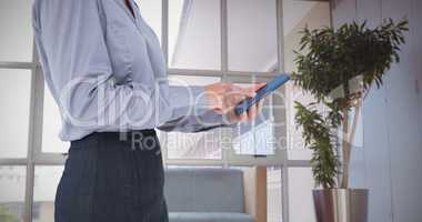 Composite image of businesswoman using her smartphone