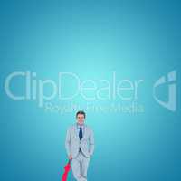 Composite image of smiling businessman with umbrella