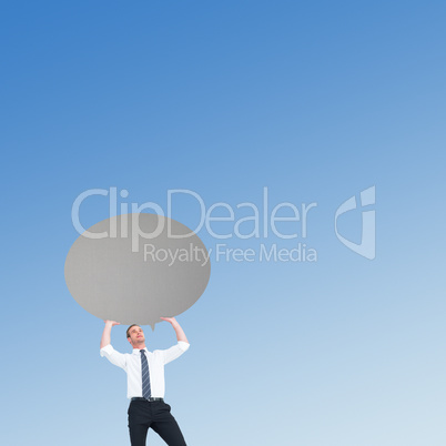 Composite image of businessman holding a speech bubble