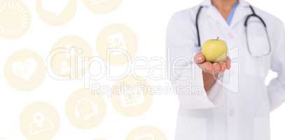 Composite image of smiling doctor offering an apple