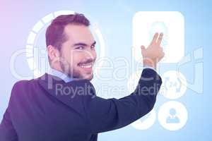 Composite image of smiling businessman pointing these fingers