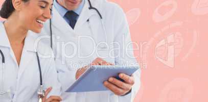Composite image of happy doctors looking at clipboard