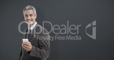 Composite image of portrait of smiling businessman holding mobil