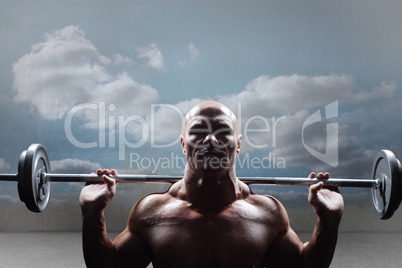Composite image of portrait of bald man lifting crossfit