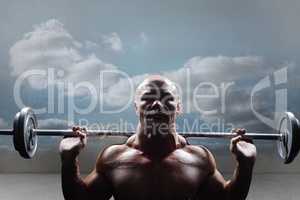 Composite image of portrait of bald man lifting crossfit
