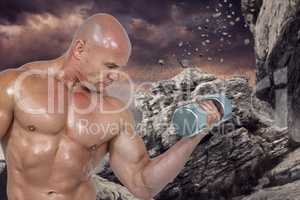 Composite image of bodybuilder concentrating while lifting dumbb