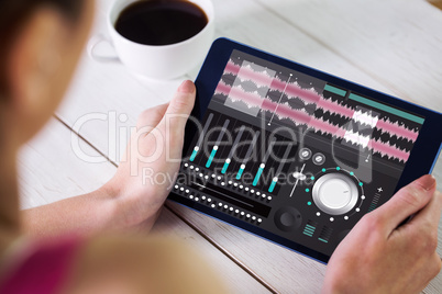 Composite image of woman using tablet pc