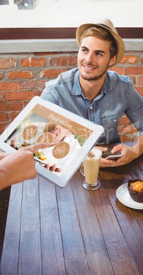 Composite image of waitress taking handsome hipsters order with