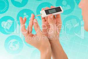 Composite image of diabetic woman using blood glucose monitor