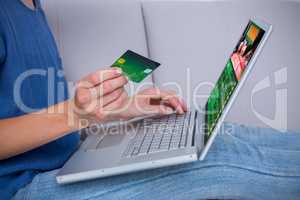 Composite image of woman doing online shopping with laptop and c