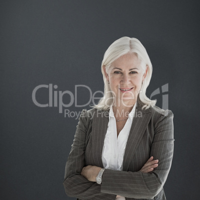 Composite image of portrait of happy businesswoman with arms cro