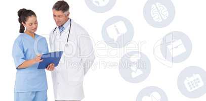 Composite image of doctor and nurse looking at clipboard