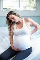 Pregnant woman with back pain sitting