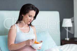 Pregnant woman eating fruit