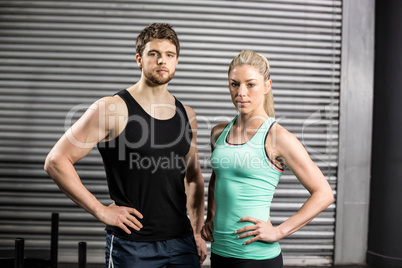 Fit couple with hands on hips