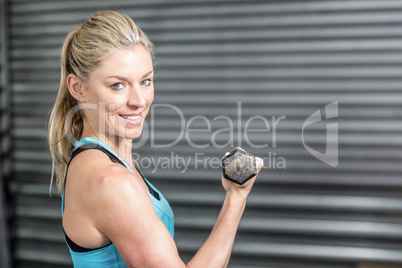 Fit woman lifting dumbbells