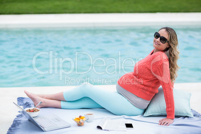 Pregnant woman relaxing outside