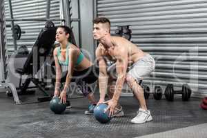 Fit couple doing ball exercise