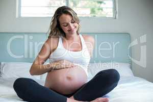 Pregnant woman resting on her bed