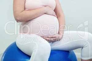 Pregnant woman sitting on exercise ball