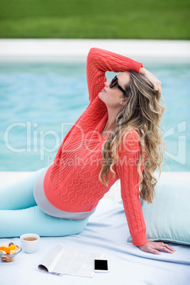 Pregnant woman relaxing outside