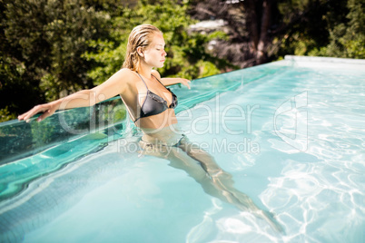 Beautiful blonde in the pool smiling