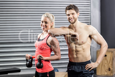 Couple posing with dumbbells