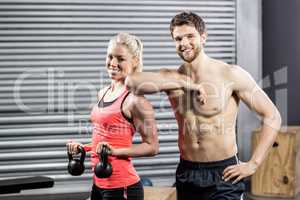 Couple posing with dumbbells